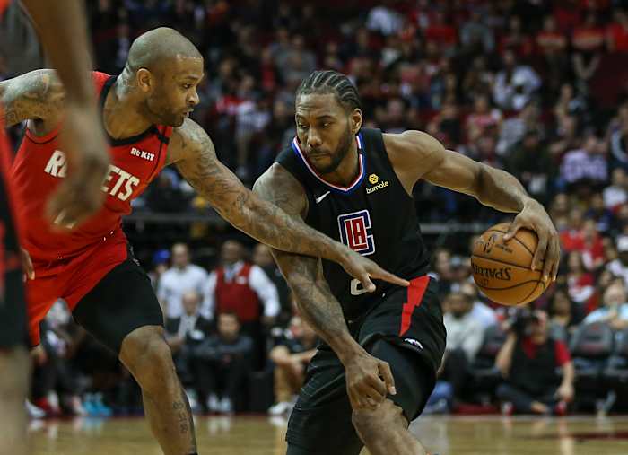Mar 5, 2020; Houston, Texas, USA; Los Angeles Clippers forward Kawhi Leonard (2) dribbles the ball as Houston Rockets forward P.J. Tucker (17) defends during the third quarter at Toyota Center. Mandatory Credit: Troy Taormina-USA TODAY Sports